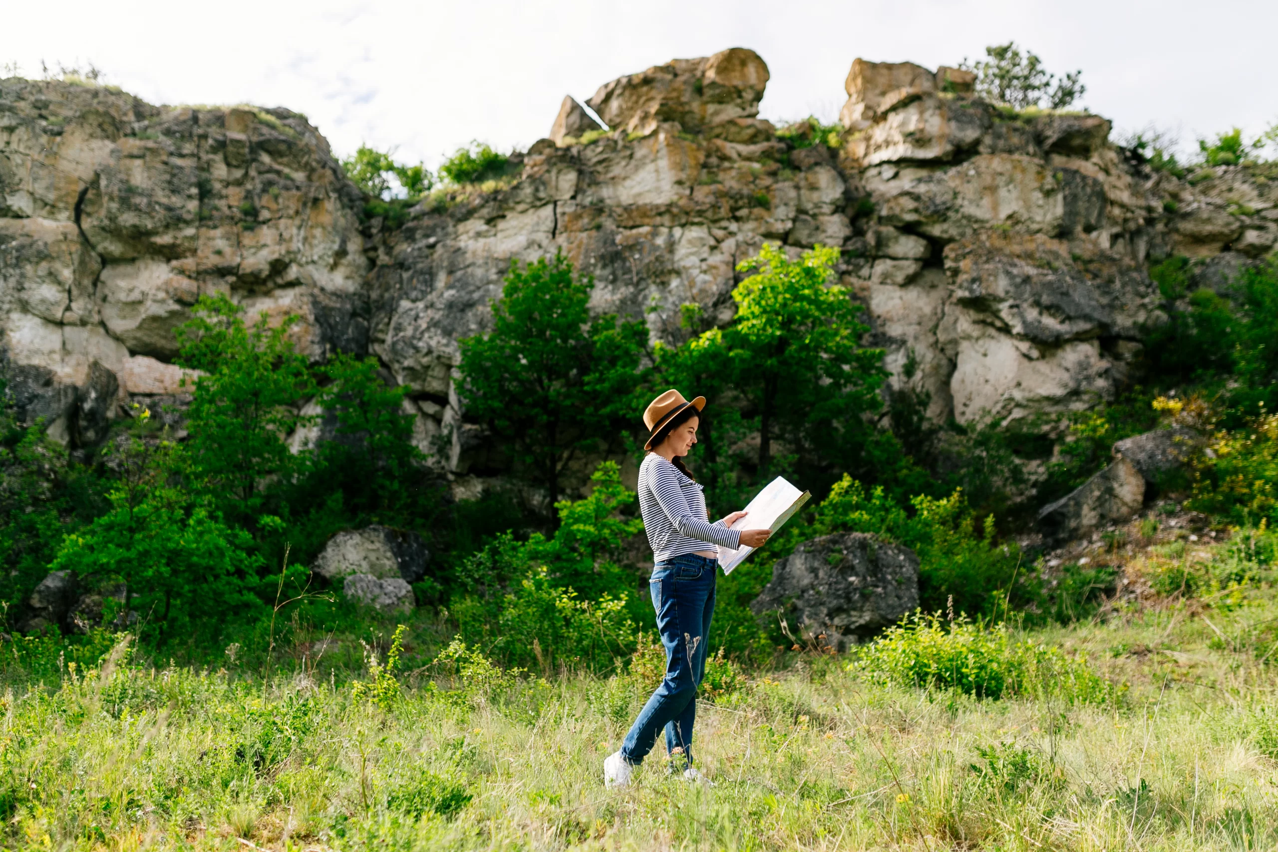 woman-looking-map-nature.webp
